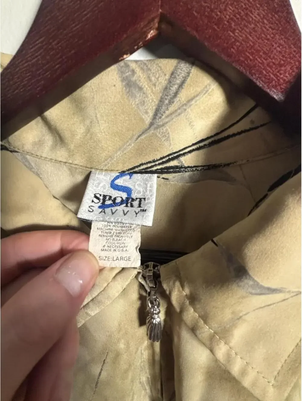 90s Sportswear Jacket with black leaf-like graphics on beige background